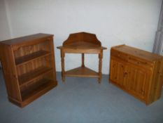 THREE ITEMS - A PINE STAND, A PINE BOOKSHELF AND A PINE UNIT