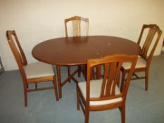 A TEAK DINING SET WITH FOUR NATHAN CHAIRS AND A DROP LEAF GATELEG TABLE