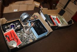 TWO TRAYS OF ASSORTED METALWARE TO INCLUDE FLATWARE, PLACEMATS ETC