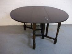 AN OAK DROP LEAF TABLE