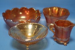 FOUR PIECES OF CARNIVAL GLASS TO INCLUDE TWO FOOTED BOWLS, A FOOTED JUG AND A FLAT BOTTOMED BOWL