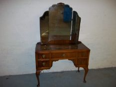 A WALNUT TRIPLE MIRROR DRESSING TABLE