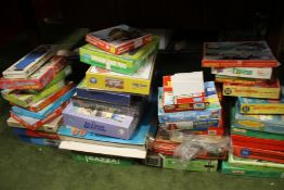 A LARGE QUANTITY OF VINTAGE JIGSAWS, BOXED GAMES ETC.