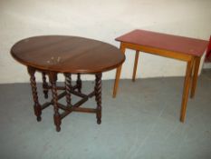 AN ANTIQUE OAK DROP LEAF TABLE AND A FORMICA TOPPED KITCHEN TABLE
