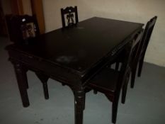 A LARGE EBONISED TYPE BLACK WOOD / CAST IRON DINING SET WITH FOUR CHAIRS, SOME HEAT MARKS TO TOP