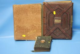 AN EDWARDIAN POSTCARD ALBUM AND CONTENTS TOGETHER WITH TWO VICTORIAN PHOTOGRAPH ALBUMS