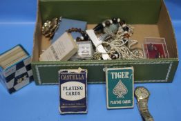 A QUANTITY OF ASSORTED COSTUME JEWELLERY, PLAYING CARDS, WRIST WATCH ETC.