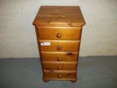 A PINE FIVE DRAWER CHEST WITH BUN FEET