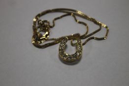 A DIAMOND HORSE SHOE PENDANT, 13 OLD BRILLIANT CUT STONES (COLOUR H/I, CLARITY VS1/VS2), TOTAL