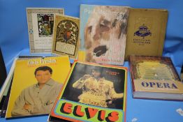 A SMALL COLLECTION OF VINTAGE ELVIS CALENDARS, PAUL MCCARTNEY PAINTING BOOK AND A BOOK ON OPERA