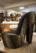 A DESIGNER LEOPARD SKINNED STILETTO STYLE CHAIR