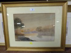 A GILT FRAMED AND GLAZED WATERCOLOUR DEPICTING A RIVER LANDSCAPE AT SUNSET SIGNED LOWER LEFT C.H
