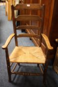 AN OAK WICKERSEAT LADDERBACK ARMCHAIR