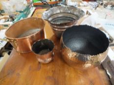 A COPPER TWIN HANDLED PLANTER' TOGETHER WITH THREE EMBOSSED COPPER VASES (4)