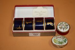 A BOXED SET OF FOUR BILSTON ENAMEL ON COPPER NAPKIN RINGS TOGETHER WITH TWO BILSTON AND BATTERSEA