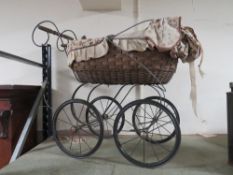 A REPRODUCTION WICKER DOLLS PRAM