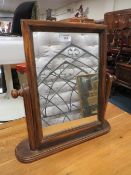 A MODERN SWING MIRROR OF SMALL PROPORTIONS