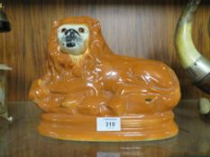 A STAFFORDSHIRE STYLE LION' with glass eyes' W 29 cm