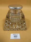 A LARGE HEAVY CUT GLASS DESK INKWELL WITH HALLMARKED SILVER MOUNTS - LONDON 1909