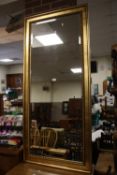 A LARGE MODERN GILT WALL MIRROR 165 CM X 75 CM
