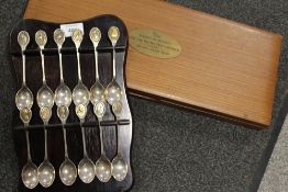 A SET OF TWELVE HALLMARKED SILVER RSPB INTEREST SPOONS WITH BIRD FINIALS ON HANGING WALL RACK