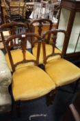 A SET OF FOUR ANTIQUE MAHOGANY DINING CHAIRS WITH CARVED DETAIL