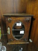 AN ANTIQUE OAK SMOKERS CABINET