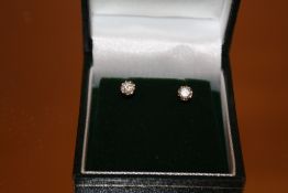 A PAIR OF 9CT GOLD DIAMOND SOLITAIRE STUD EARRINGS