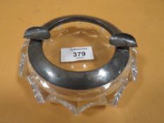 A HEAVY SILVER MOUNTED CUT GLASS ASHTRAY