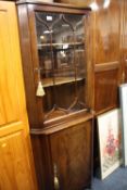 A REPRODUCTION MAHOGANY GLAZED CORNER CABINET