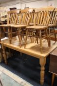 A HONEY PINE KITCHEN TABLE' H-78 CM W-92 CM L-153 CM TOGETHER WITH SIX TRADITIONAL STYLE SLAT BACK