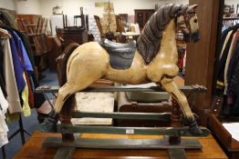 A MODERN CARVED AND PAINTED WOOD TRESTLE ROCKING HORSE OVERALL H-79 CM W-91 CM