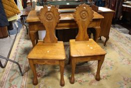 A PAIR OF SOLID OAK HALL STYLE CHAIRS