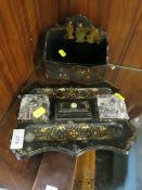 A LACQUERED TWIN INKWELL DESK STAND' TOGETHER WITH A LACQUERED WALL POCKET (2)