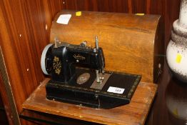 A VINTAGE VULCAN CASED SEWING MACHINE