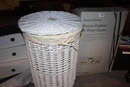 A BOXED GOOSE FEATHER AND DOWN DUVET TOGETHER WITH A WICKER LAUNDRY BASKET