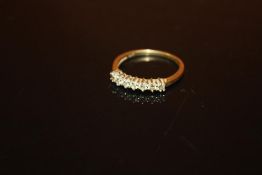 A 9CT GOLD SEVEN STONE DIAMOND RING - SIZE P - WEIGHT 1.8 GRAMS APPROX