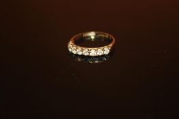 A HALLMARKED 9 CARAT GOLD SEVEN STONE DRESS RING - SIZE N - WEIGHT 1.7 GRAMS APPROX