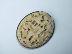 A LARGE ANTIQUE CARVED CANTONESE IVORY BROOCH