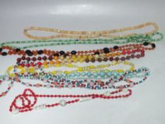SEVEN VINTAGE GLASS NECKLACES