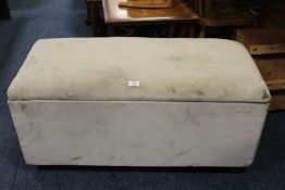 A MODERN UPHOLSTERED OTTOMAN