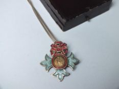 AN SILVER & ENAMEL O.B.E BADGE ON A SILVER CHAIN