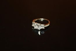 A LADIES 9 CARAT WHITE GOLD THREE STONE DRESS RING - SIZE K 1/2 - WEIGHT 2.1 GRAMS APPROX
