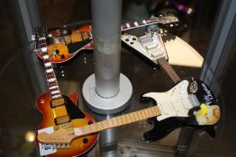 FOUR ORNAMENTAL MODERN MINIATURE GUITARS
