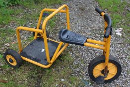 A CHILDS RABO TRICYCLE WITH RIDE ON BACK