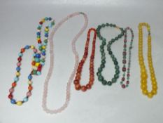 SEVEN VINTAGE GLASS NECKLACES