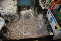 A QUANTITY OF CUT GLASS TO INCLUDE DECANTERS, JUGS AND DRINKING GLASSES