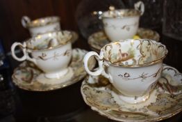 A SET OF FOUR ANTIQUE HAND PAINTED CUPS AND SAUCERS DECORATED WITH COUNTRY SCENES PLUS ONE
