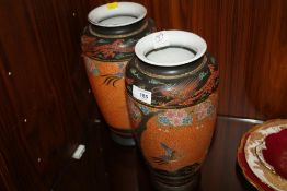 A PAIR OF ORIENTAL STYLE VASES DECORATED WITH DRAGONS AND BIRDS