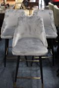 A MODERN SET OF THREE VELVET BARSTOOLS